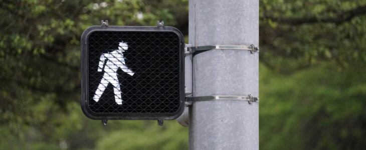 crosswalk sign indicating it is safe to cross