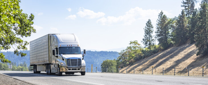 White semi driving on a mountain highway