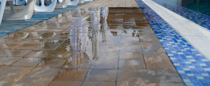 wet tiles next to an outdoor pool