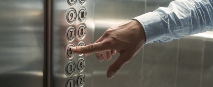 Man pressing elevator button