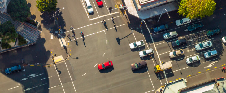 Aerial view of a busy intersection with cars and pedestrians