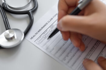 Woman filling Health Insurance claim form