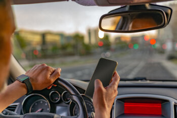 Man texting on cellphone while driving