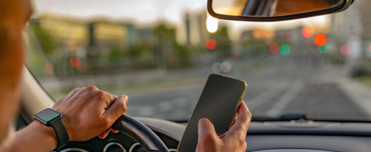 Man texting on cellphone while driving