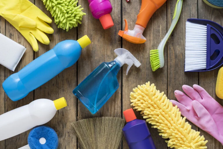 Cleaning products arranged on a wooden board