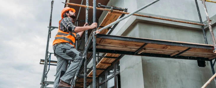 construction worker on scaffolding outside of building